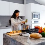 middle aged woman cooking healthy